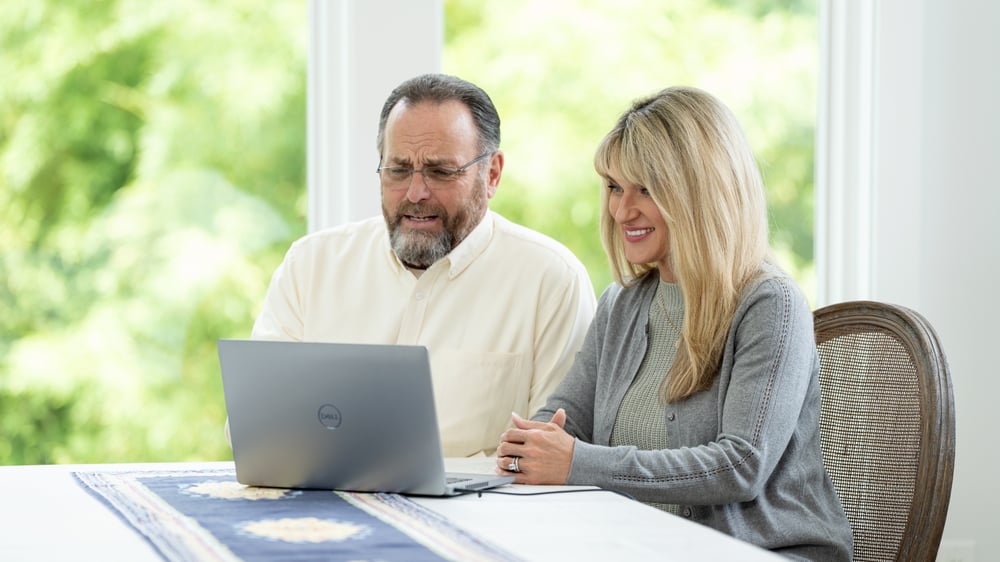 Couple researches on lap top